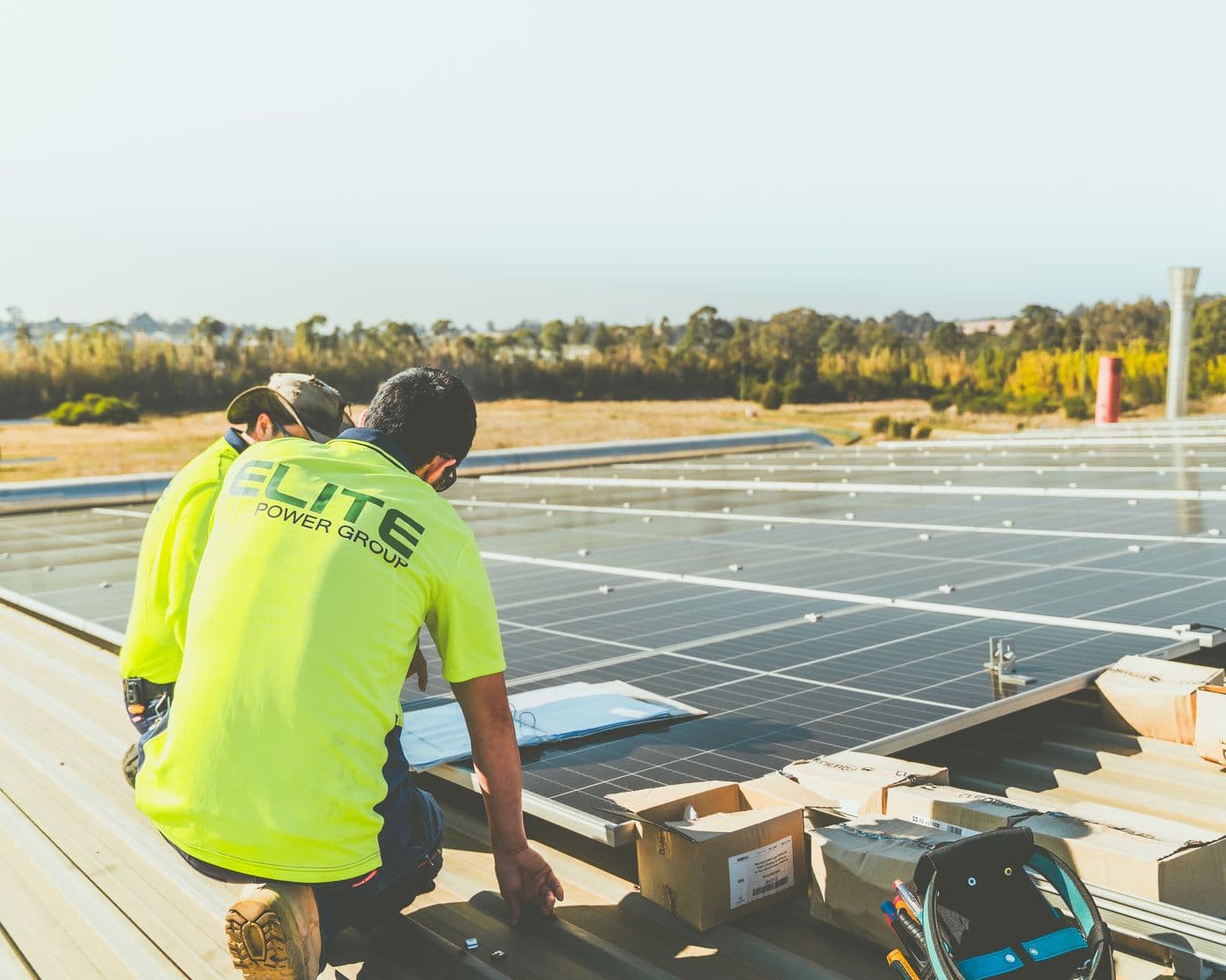 RACHFLO technicians working on a commercial rooftop solar array