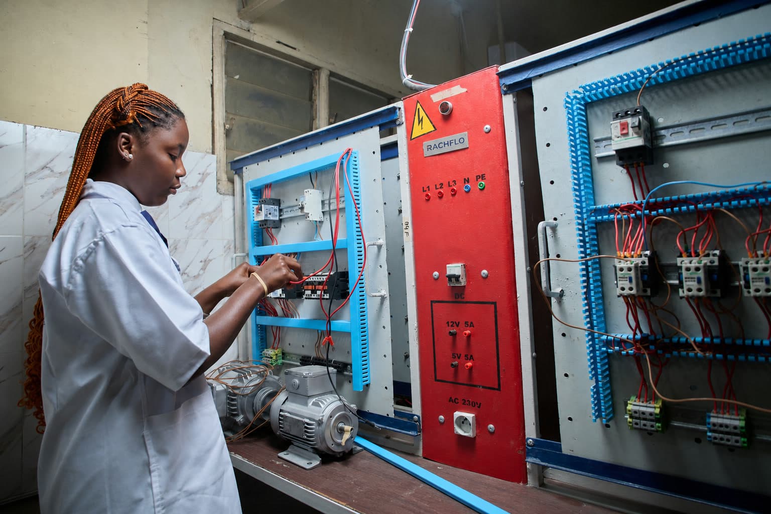 Technician testing an electrical control panel before handover