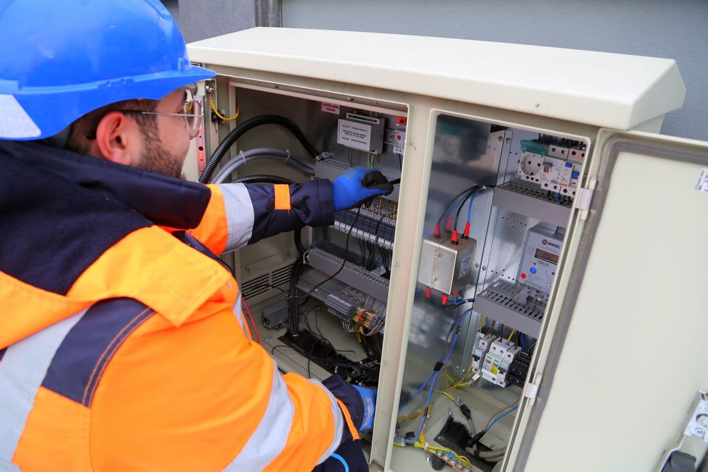 Engineer working inside an electrical cabinet