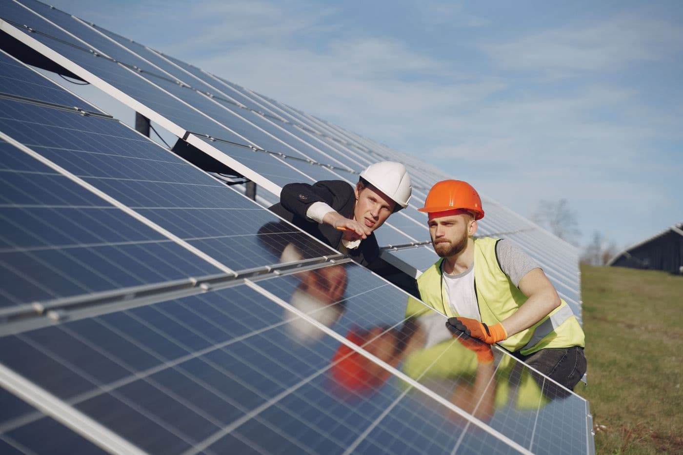 Technicians inspecting a commissioned solar array